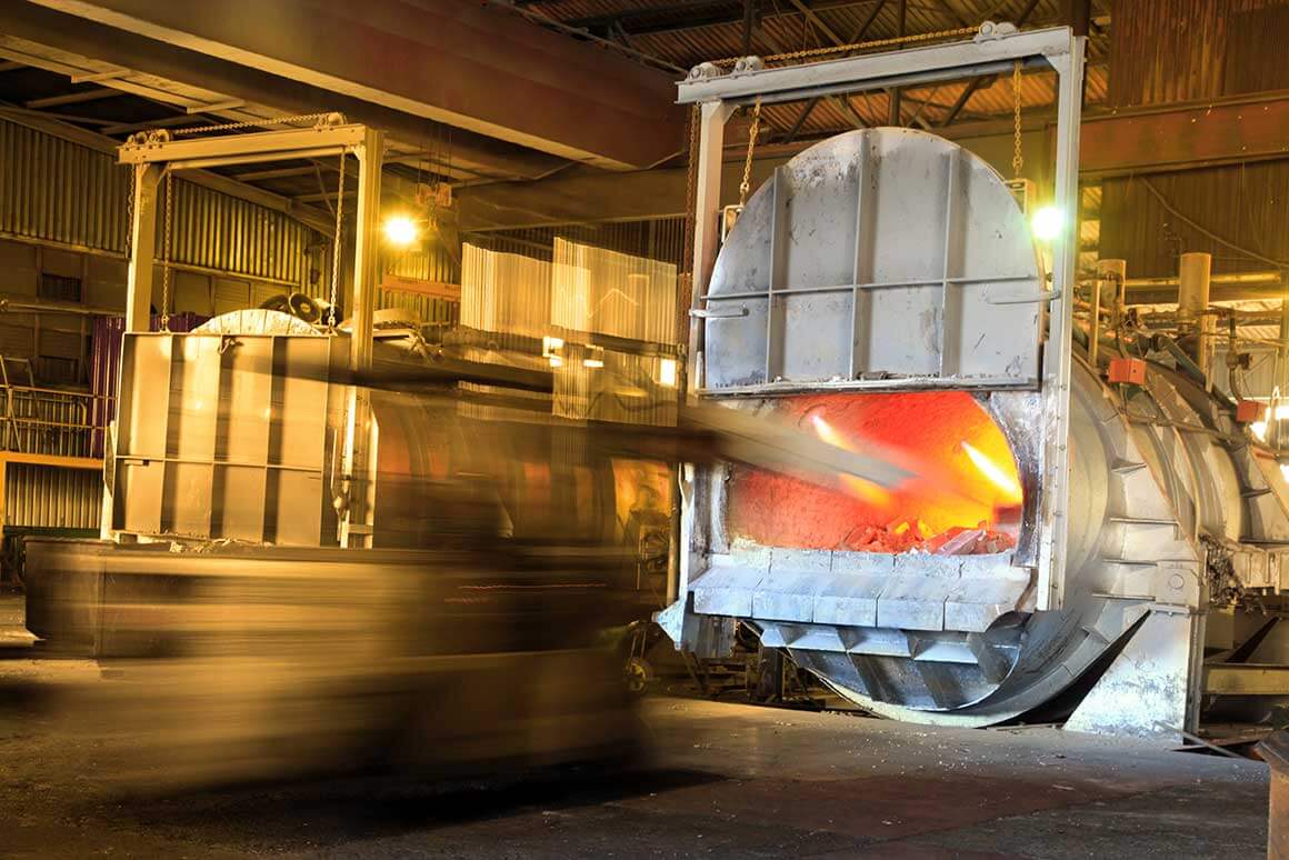 Loading aluminium in a furnace for recycling.